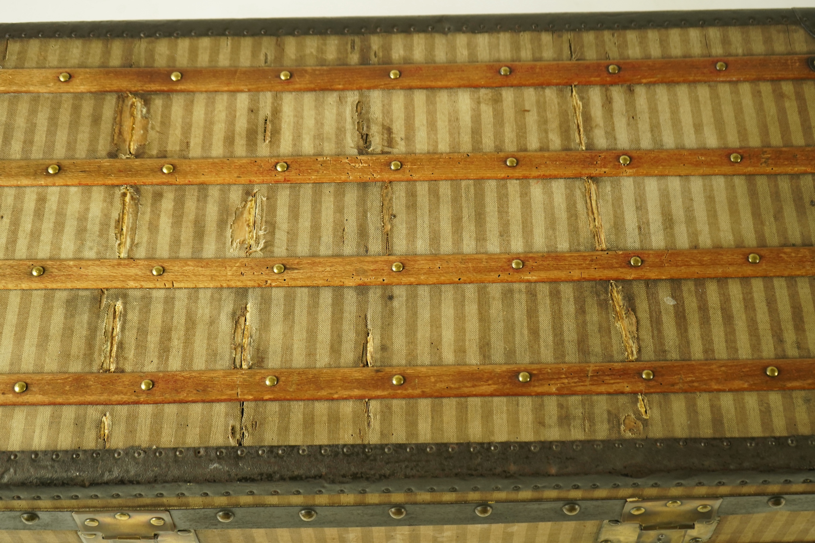 A vintage Louis Vuitton trunk with paper label to the interior numbered 142678, height 43cm, width 90cm, depth 48cm